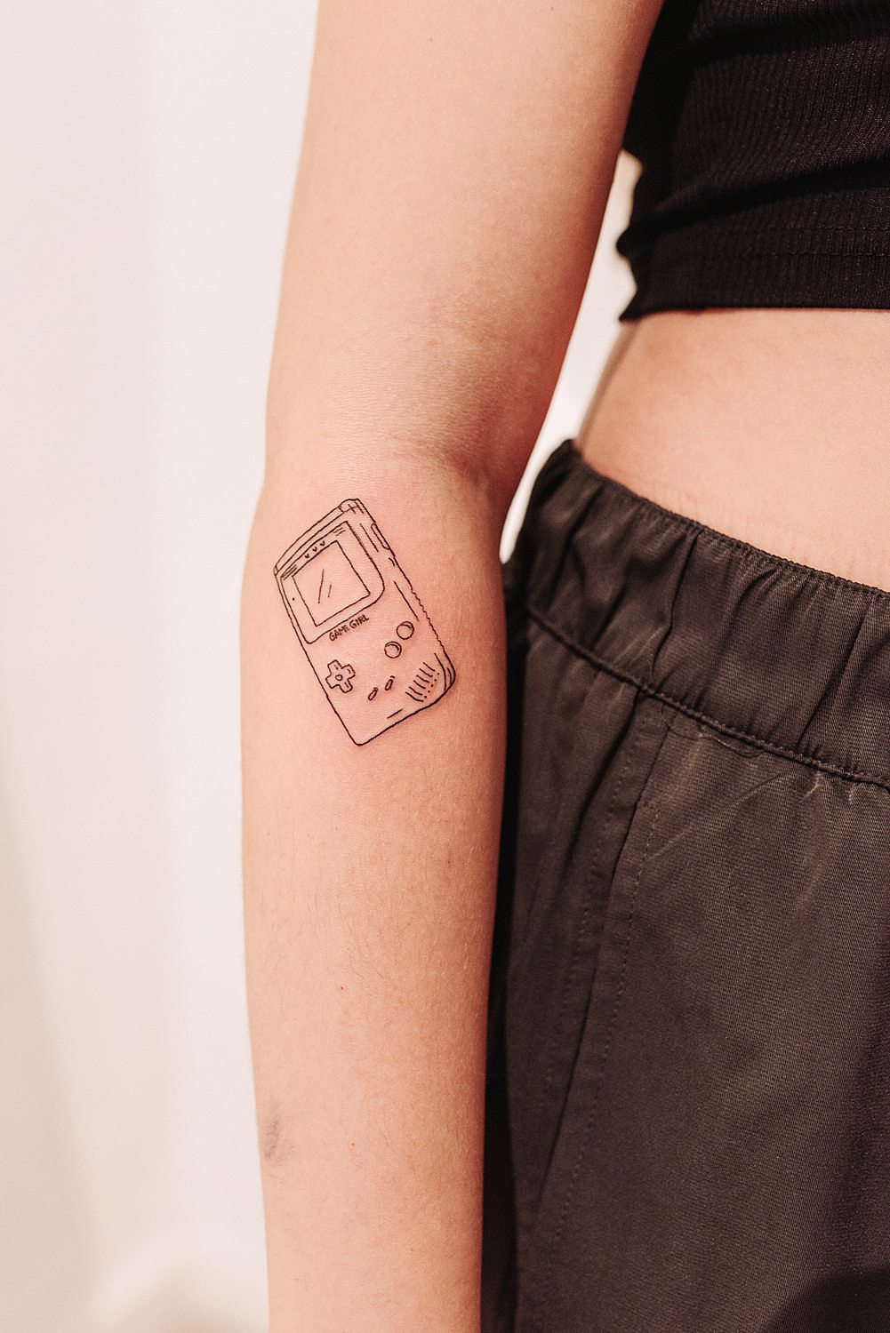 Tatuaje de videoconsola Game Girl/Game Boy en brazo de mujer